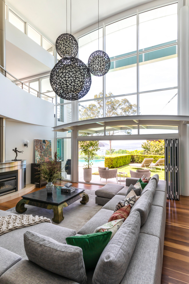 Inspiration for a contemporary living room in Sydney with white walls, medium hardwood floors and no tv.