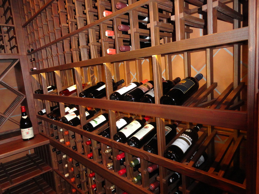 Photo of a small traditional wine cellar in San Diego with ceramic floors and display racks.