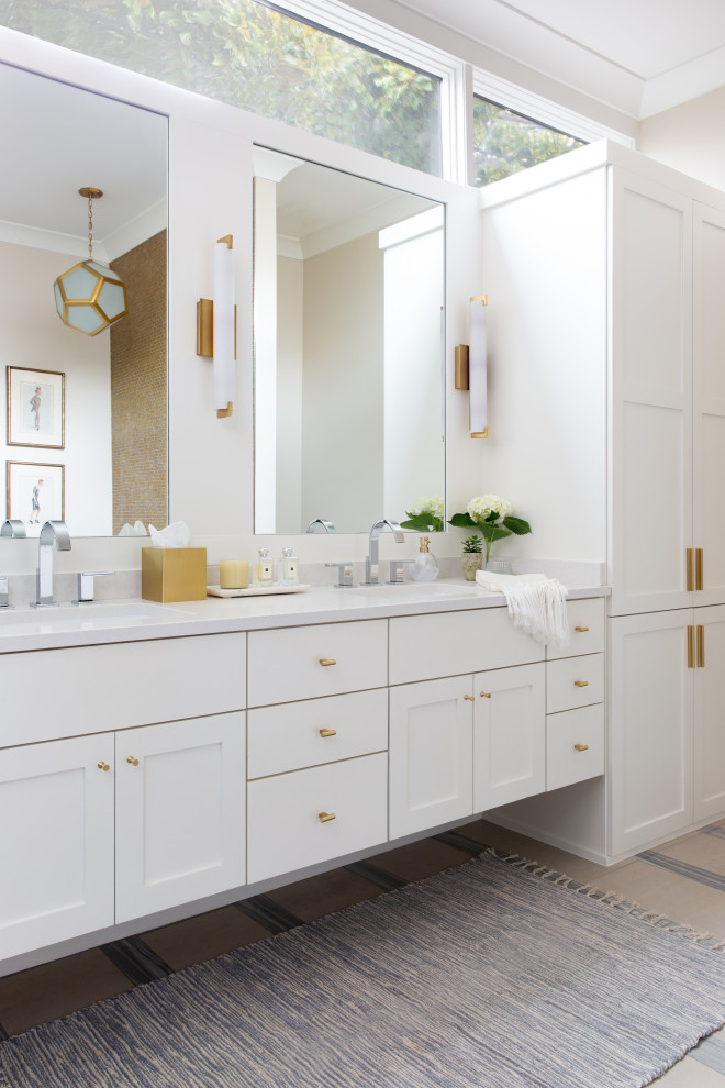 Traditional ensuite bathroom in Austin with shaker cabinets, white cabinets, beige walls, marble flooring, engineered stone worktops, beige floors, white worktops, double sinks, a floating vanity unit and all types of wall treatment.