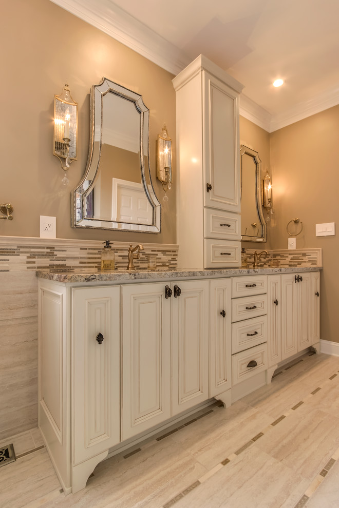 Inspiration for a large modern master bathroom in Other with louvered cabinets, distressed cabinets, a freestanding tub, an alcove shower, gray tile, white tile, matchstick tile, beige walls, porcelain floors, an undermount sink and granite benchtops.