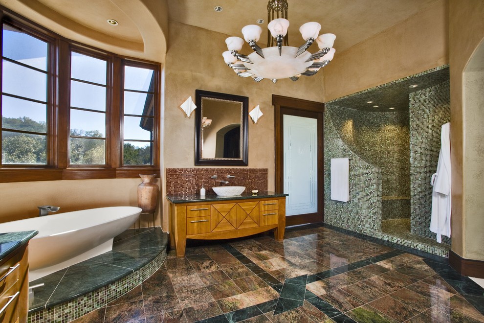 This is an example of a country bathroom in Austin with a freestanding tub, mosaic tile and a vessel sink.