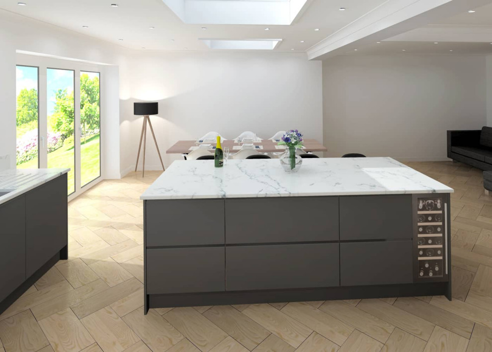 This is an example of a medium sized contemporary l-shaped open plan kitchen in Sussex with a built-in sink, flat-panel cabinets, grey cabinets, quartz worktops, white splashback, black appliances, porcelain flooring, an island, beige floors and white worktops.