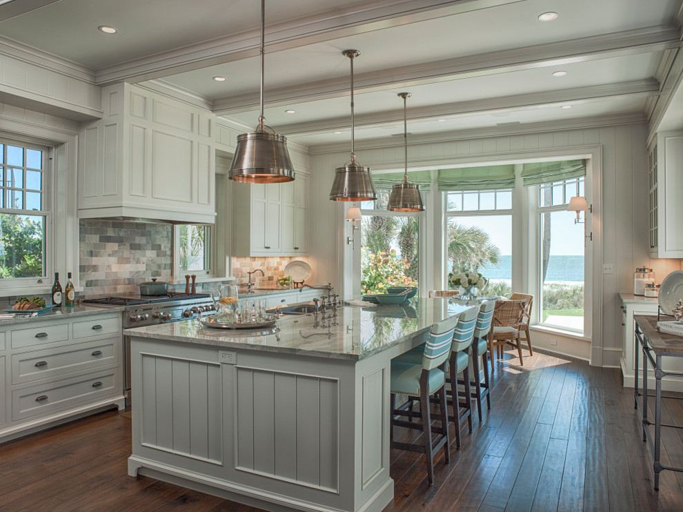Design ideas for a large beach style u-shaped kitchen in Jacksonville with a double-bowl sink, beaded inset cabinets, white cabinets, quartzite benchtops, multi-coloured splashback, stone tile splashback, stainless steel appliances, medium hardwood floors and grey benchtop.