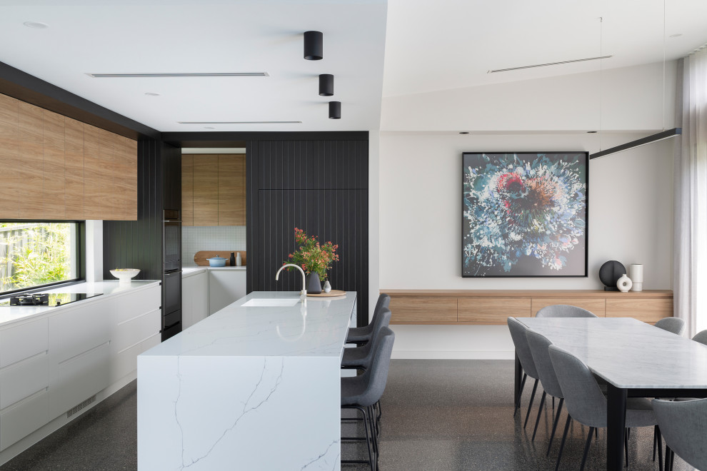 Inspiration for a contemporary eat-in kitchen in Canberra - Queanbeyan with a single-bowl sink, flat-panel cabinets, white cabinets, window splashback, with island, grey floor and white benchtop.