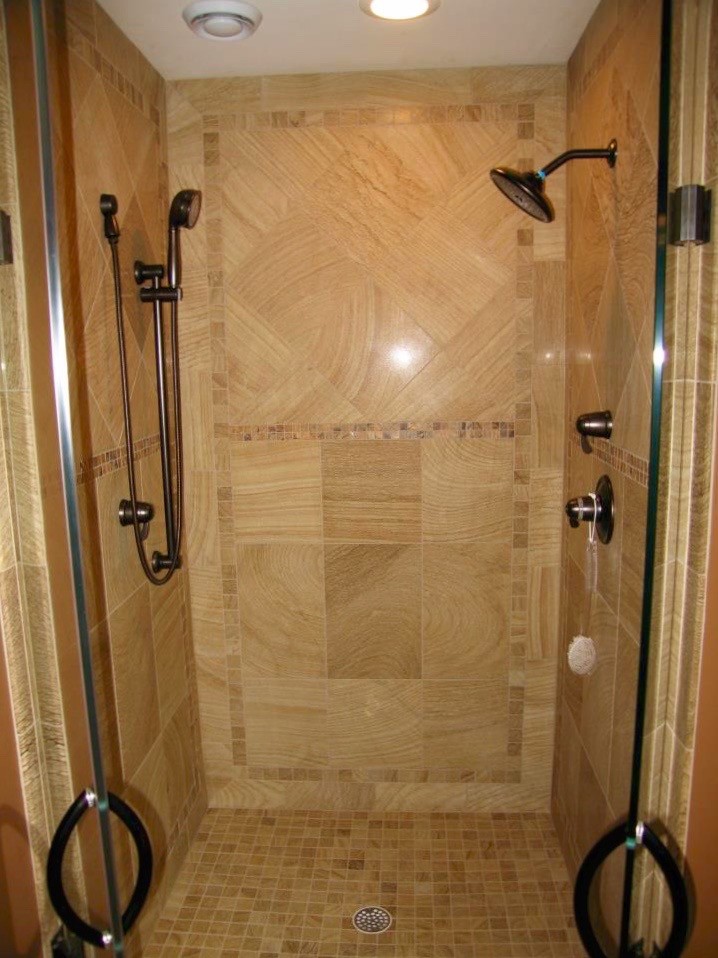Photo of a transitional bathroom in Other with an alcove shower, beige tile, porcelain tile and a hinged shower door.