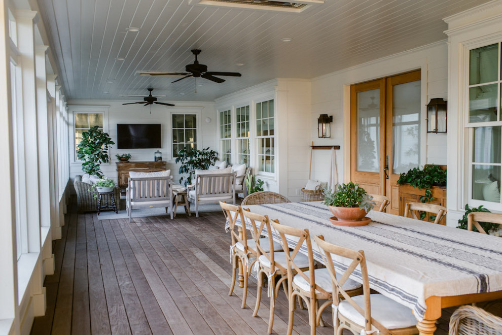 Photo of a large farmhouse back screened veranda in Dallas with decking and a roof extension.