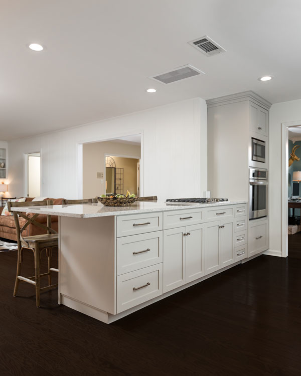 Open concept kitchen - large transitional l-shaped open concept kitchen idea with shaker cabinets and a peninsula