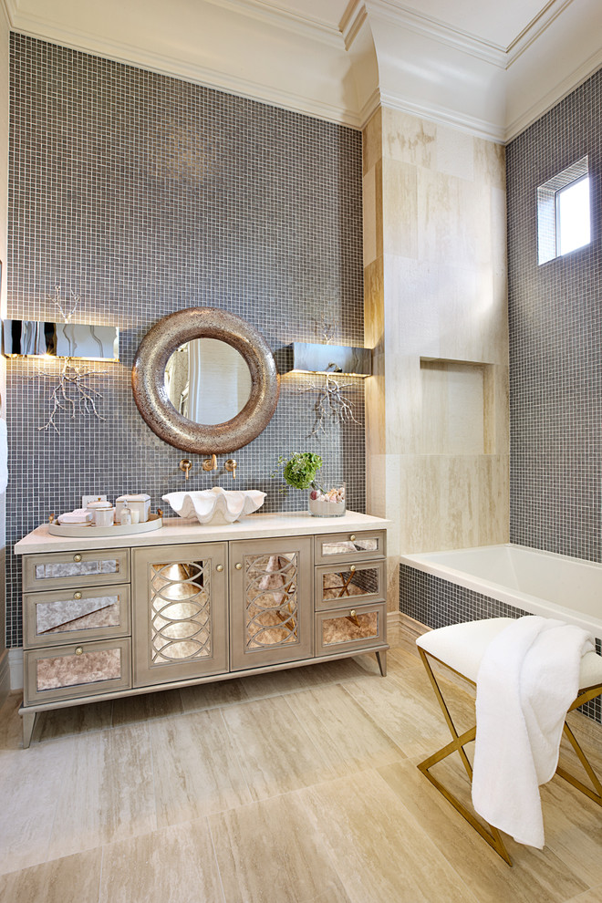 Eclectic bathroom in Las Vegas with a vessel sink, an alcove tub, gray tile, mosaic tile, beige cabinets and recessed-panel cabinets.