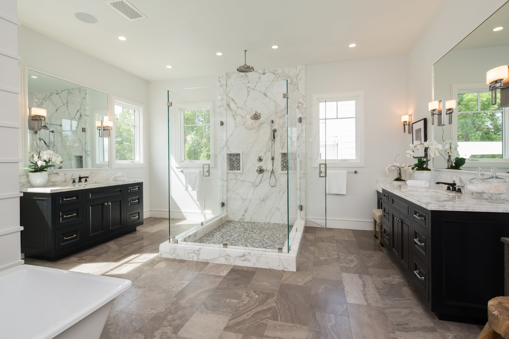 This is an example of an expansive traditional master bathroom in Los Angeles with recessed-panel cabinets, dark wood cabinets, a freestanding tub, an open shower, multi-coloured tile, marble, white walls, marble floors, an undermount sink, engineered quartz benchtops, multi-coloured floor and a hinged shower door.