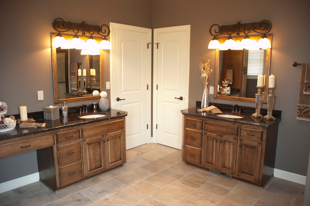 Inspiration for a large rustic master porcelain tile and gray floor alcove shower remodel with raised-panel cabinets, dark wood cabinets, gray walls, an undermount sink and granite countertops