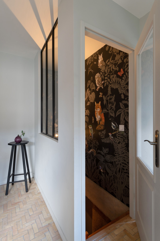Inspiration for a large contemporary vestibule in Lyon with grey walls, terra-cotta floors, a single front door, a light wood front door, beige floor and wallpaper.