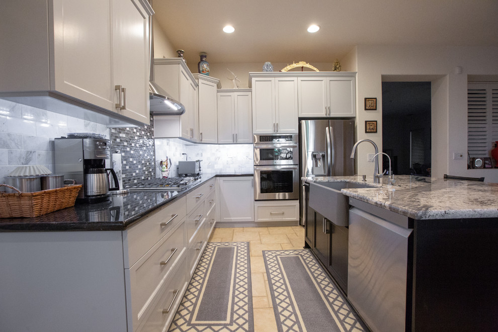 Design ideas for a large modern l-shaped eat-in kitchen in Sacramento with an undermount sink, grey cabinets, granite benchtops, grey splashback, mosaic tile splashback, stainless steel appliances, with island and black benchtop.