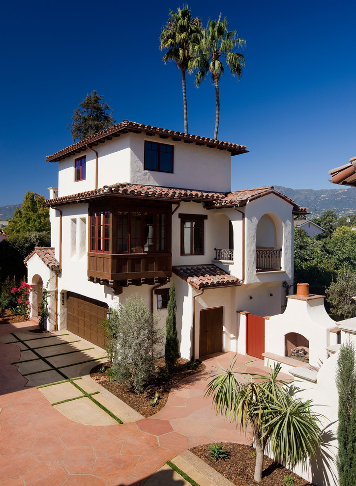 Mediterranean three-storey exterior in Santa Barbara with a hip roof.