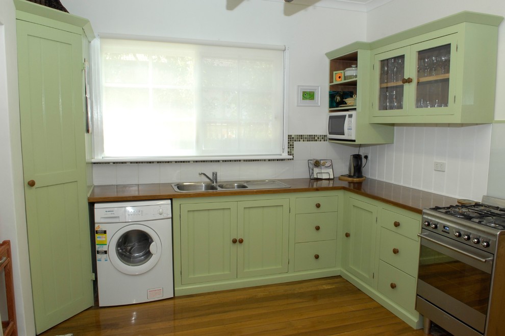 Photo of a traditional kitchen in Perth with wood benchtops.