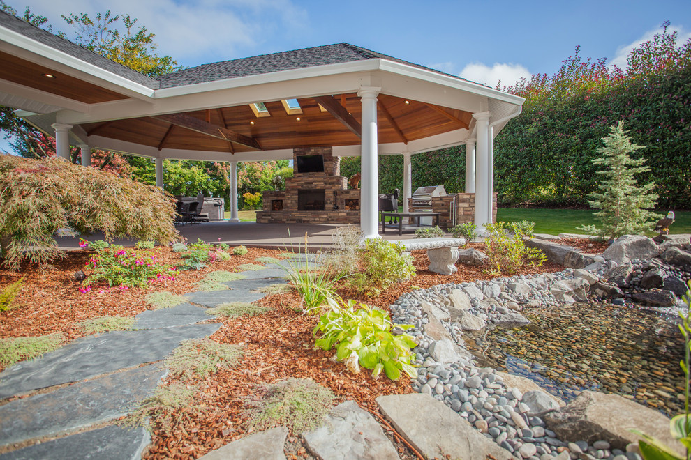 Inspiration for an expansive traditional backyard patio in Portland with an outdoor kitchen, concrete slab and a gazebo/cabana.