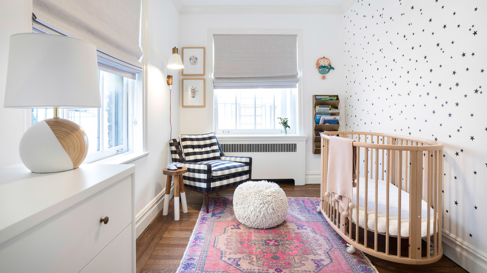 Nursery - small transitional girl brown floor and dark wood floor nursery idea in New York with white walls