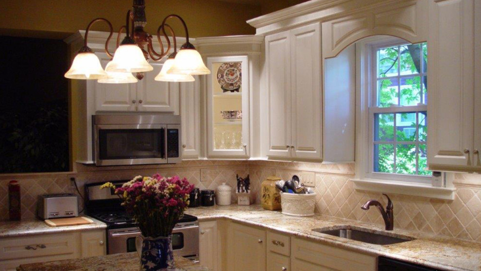 Kitchen - mid-sized transitional l-shaped dark wood floor kitchen idea with raised-panel cabinets, white cabinets, white backsplash, paneled appliances and an island