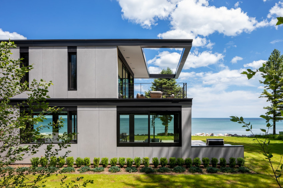 Стильный дизайн: большой, двухэтажный частный загородный дом в стиле модернизм с черной крышей - последний тренд