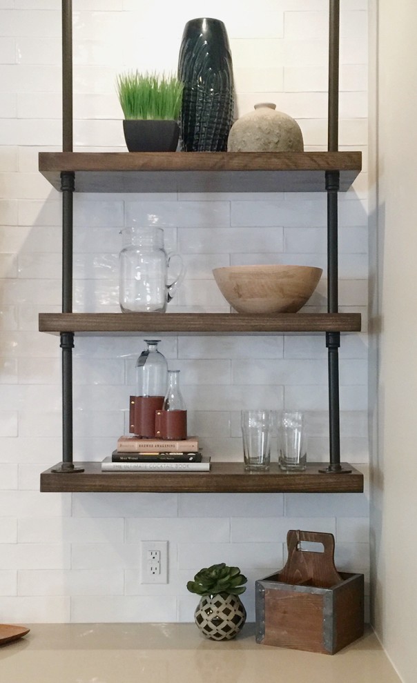 Design ideas for an industrial home bar in Indianapolis with quartzite benchtops, white splashback, subway tile splashback and ceramic floors.