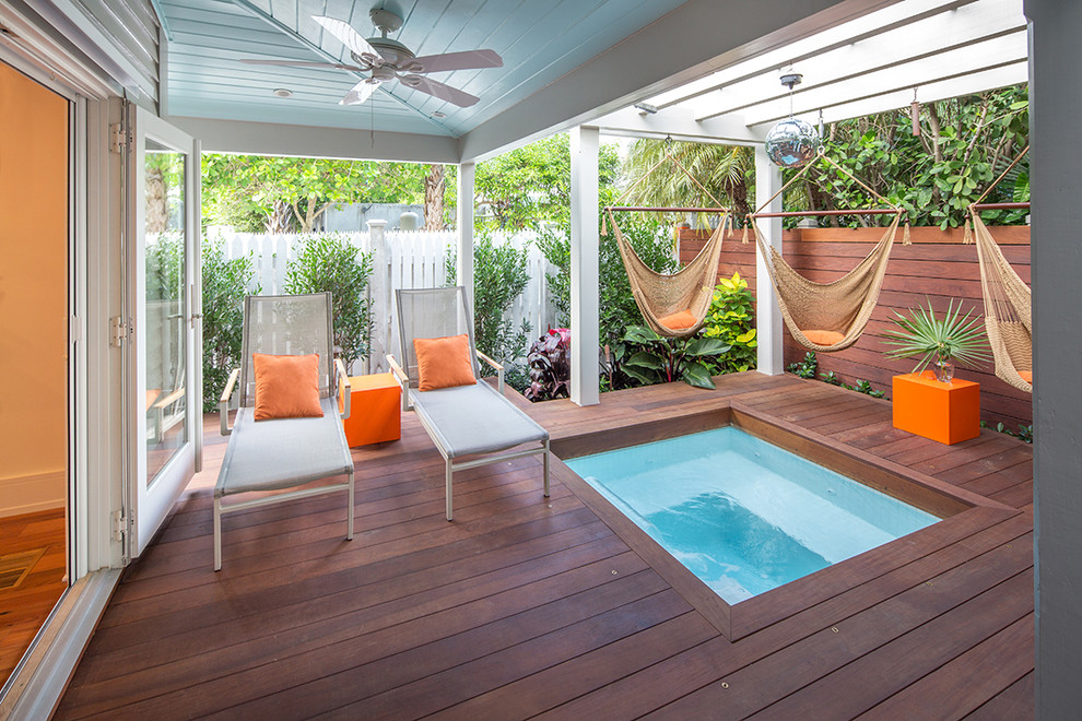 This is an example of a small tropical home design in Miami.