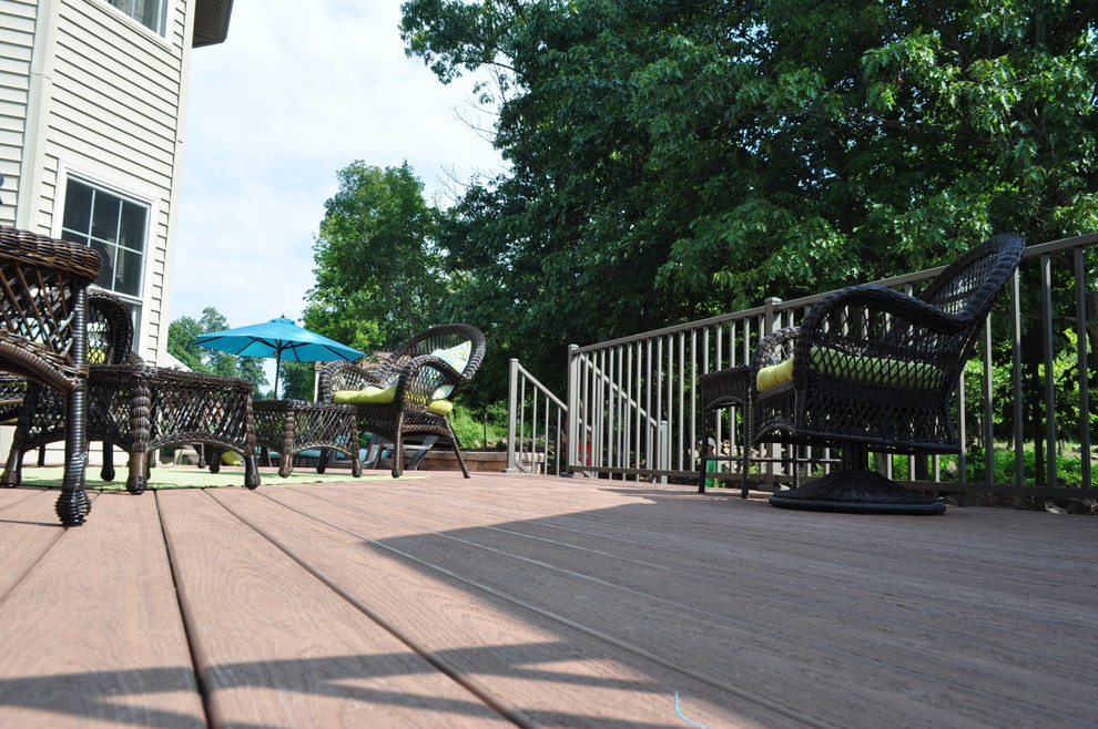 Example of a mid-sized transitional backyard deck design with a pergola