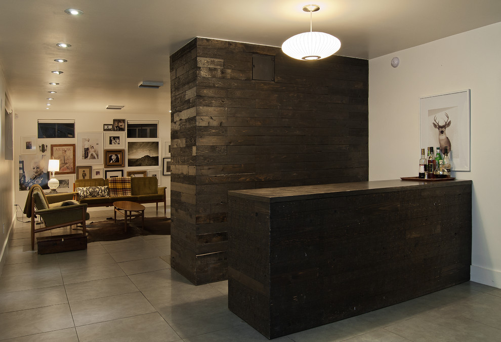 Design ideas for a mid-sized contemporary galley wet bar in Salt Lake City with flat-panel cabinets, dark wood cabinets, concrete benchtops, brown splashback, porcelain floors and grey floor.