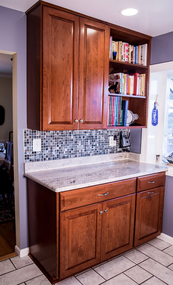 Mid-sized transitional single-wall eat-in kitchen in Baltimore with a double-bowl sink, raised-panel cabinets, medium wood cabinets, blue splashback, mosaic tile splashback, stainless steel appliances, no island, soapstone benchtops and ceramic floors.