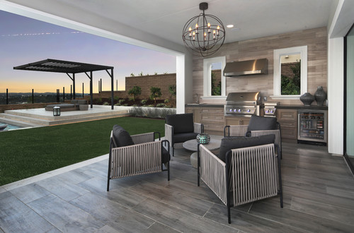 Covered patio kitchen with stainless RTA cabinets and lounge seating—material focus for outdoor durability