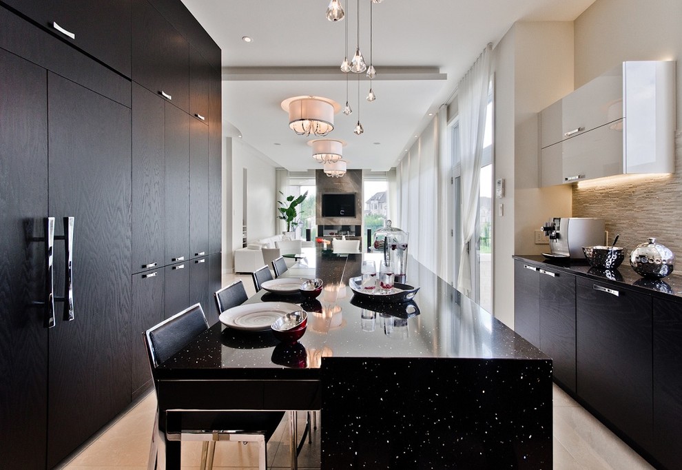 This is an example of a contemporary eat-in kitchen in Montreal with flat-panel cabinets, black cabinets, beige splashback and black benchtop.