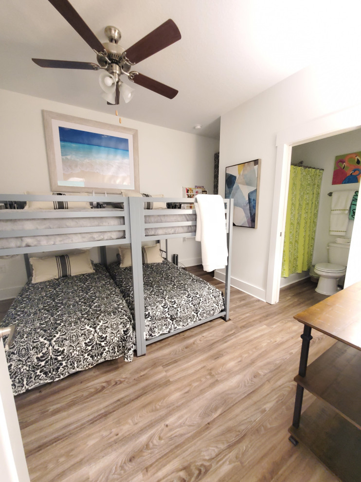 Inspiration for a mid-sized transitional guest vinyl floor and beige floor bedroom remodel with white walls