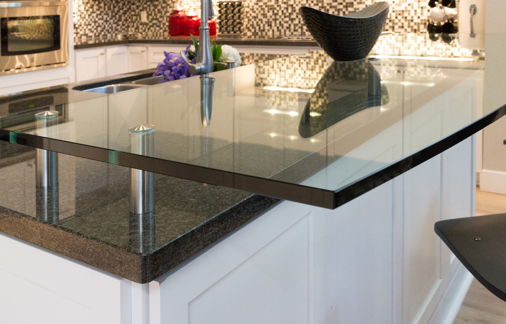 Inspiration for a huge transitional u-shaped light wood floor open concept kitchen remodel in Phoenix with a farmhouse sink, shaker cabinets, white cabinets, granite countertops, white backsplash, glass tile backsplash, stainless steel appliances and an island