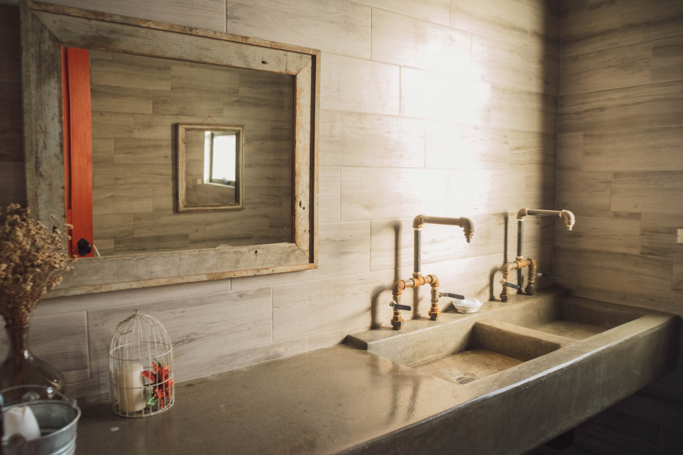 Inspiration for a mid-sized industrial 3/4 bathroom in Other with open cabinets, grey cabinets, a one-piece toilet, gray tile, porcelain tile, grey walls, mosaic tile floors, a drop-in sink, concrete benchtops, black floor, grey benchtops, a double vanity, a floating vanity, exposed beam and brick walls.