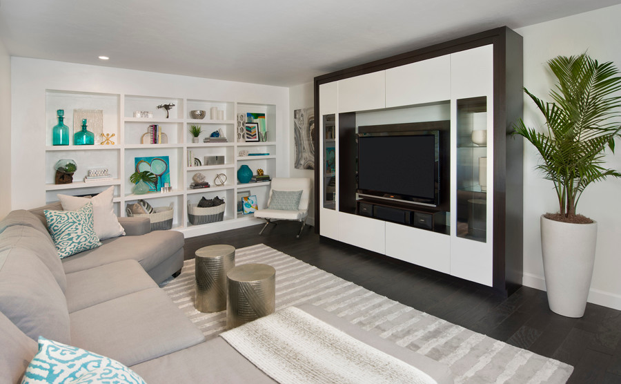 Inspiration for a mid-sized contemporary open concept family room in Miami with white walls, dark hardwood floors, a built-in media wall and brown floor.