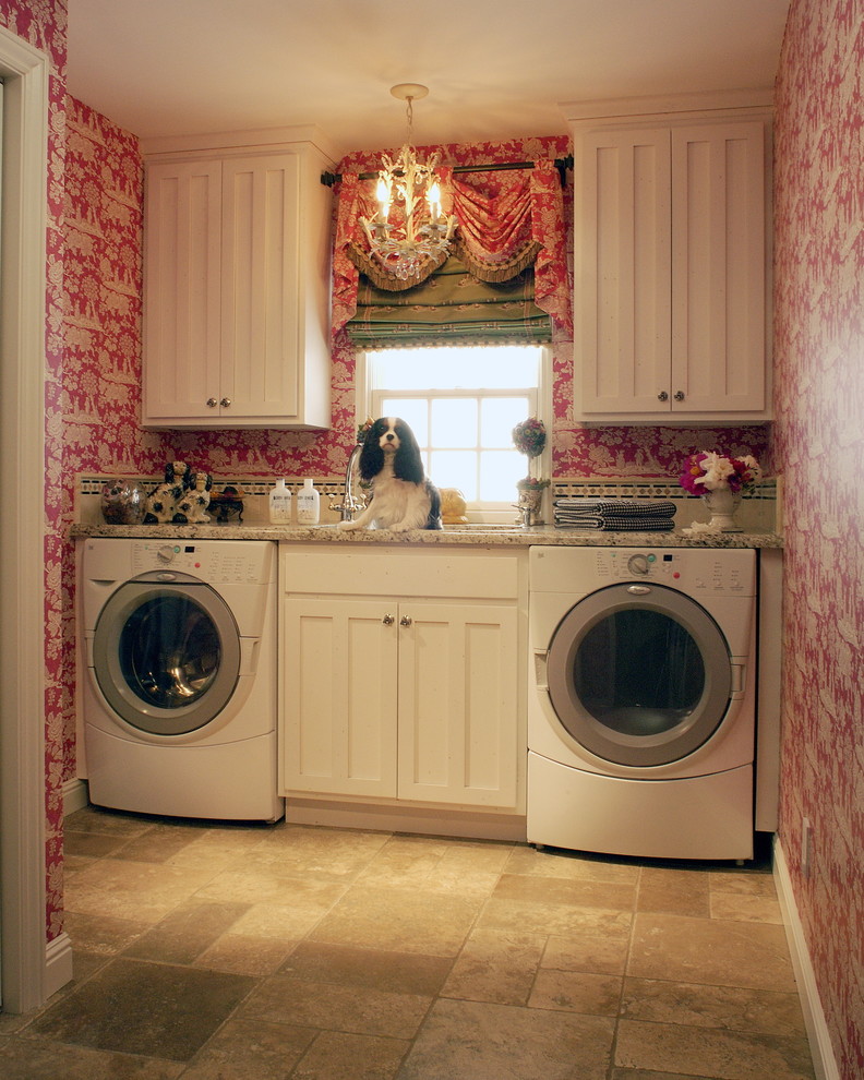 Inspiration for a traditional laundry room in Charlotte with white cabinets and beige floor.