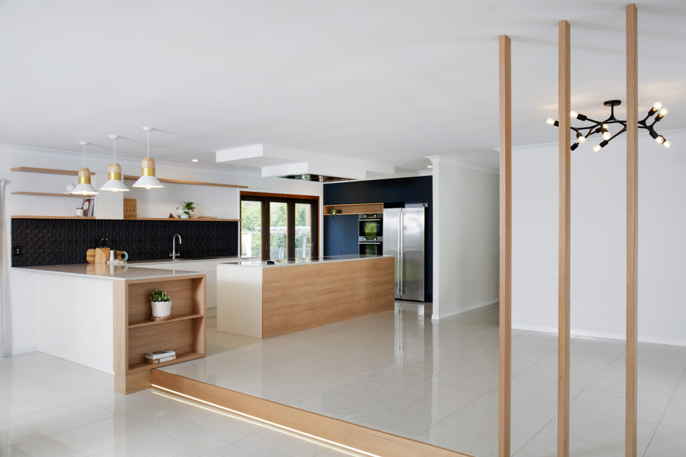 Photo of a mid-sized contemporary kitchen in Brisbane with an undermount sink, quartz benchtops, black splashback, ceramic splashback, porcelain floors, with island and beige floor.