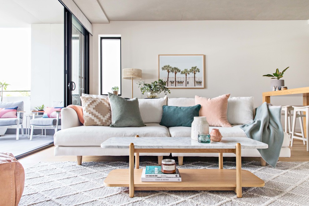 Small scandinavian open concept living room in Sydney with white walls, light hardwood floors and beige floor.