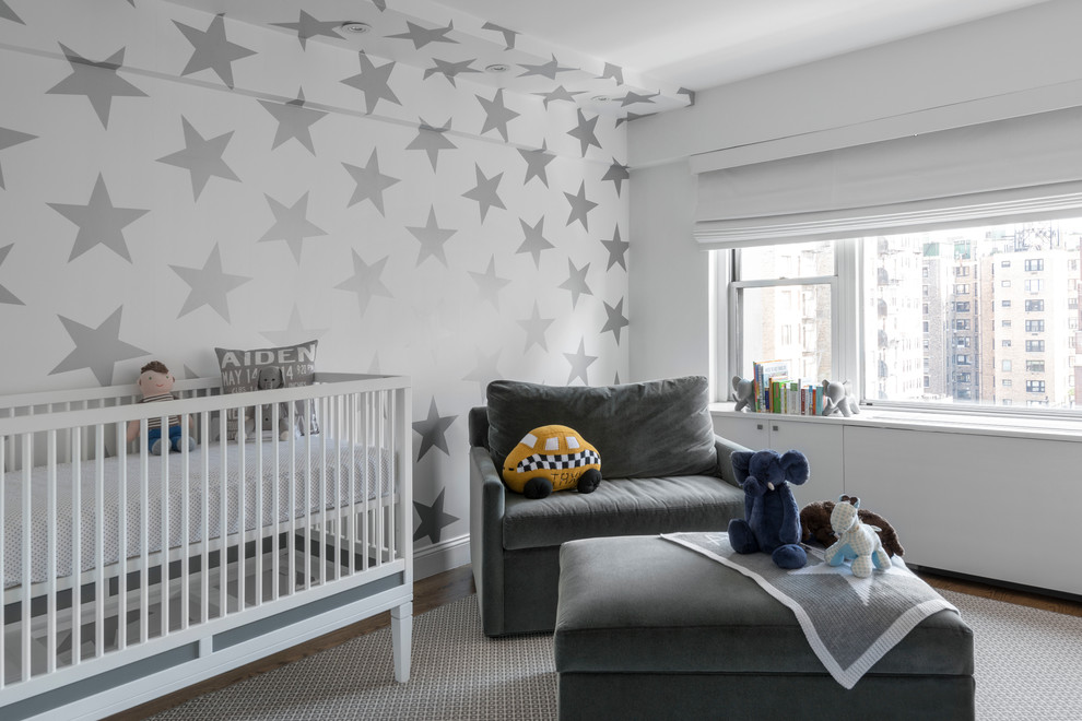 Mid-sized contemporary gender-neutral nursery in New York with multi-coloured walls, medium hardwood floors and grey floor.