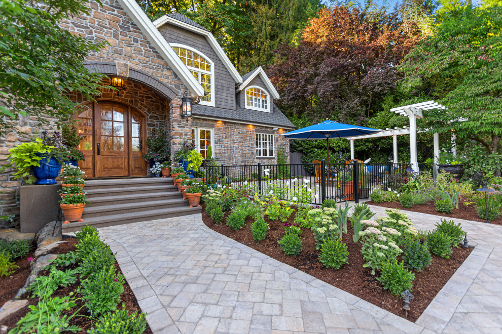 Design ideas for a large traditional front yard full sun xeriscape in Portland with concrete pavers, a metal fence and with path.