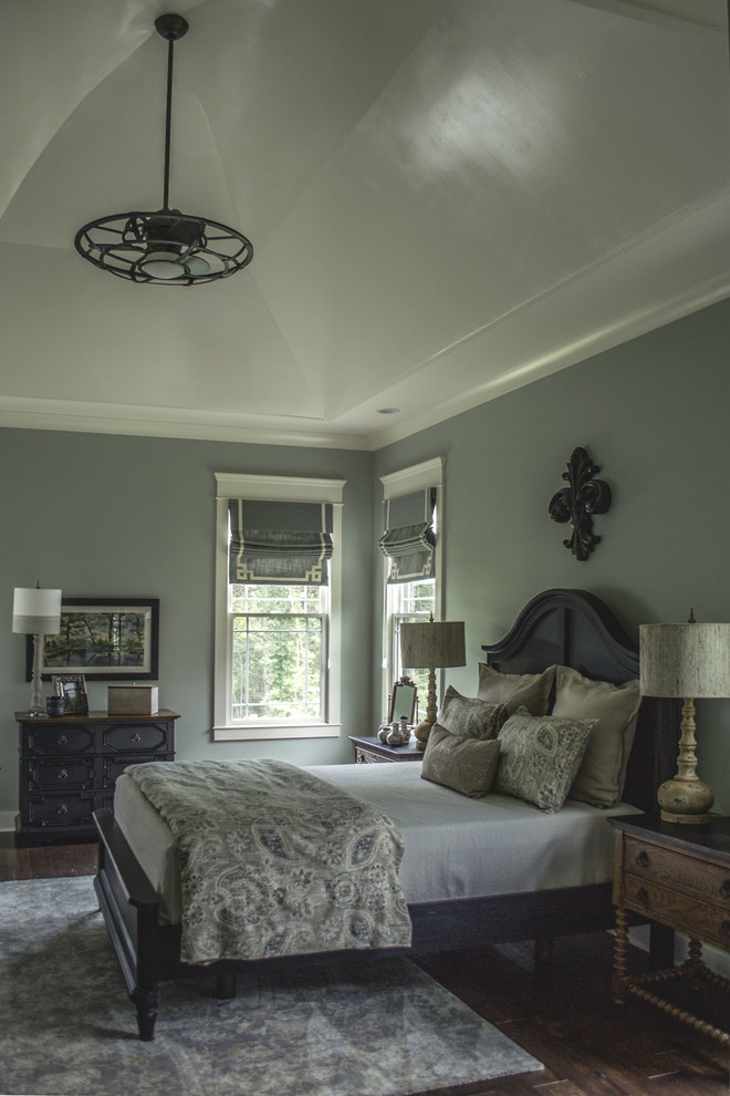 Inspiration for a traditional master bedroom in Louisville with blue walls and dark hardwood floors.