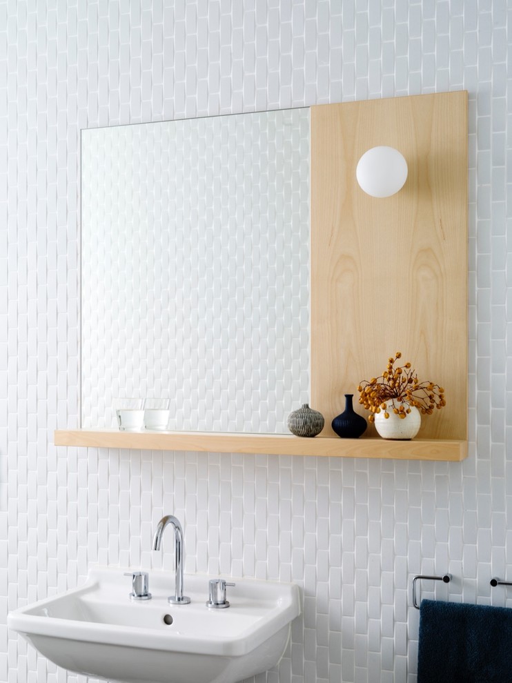 Inspiration for a large contemporary powder room in Sydney with light wood cabinets, white tile, porcelain tile, white walls and a wall-mount sink.