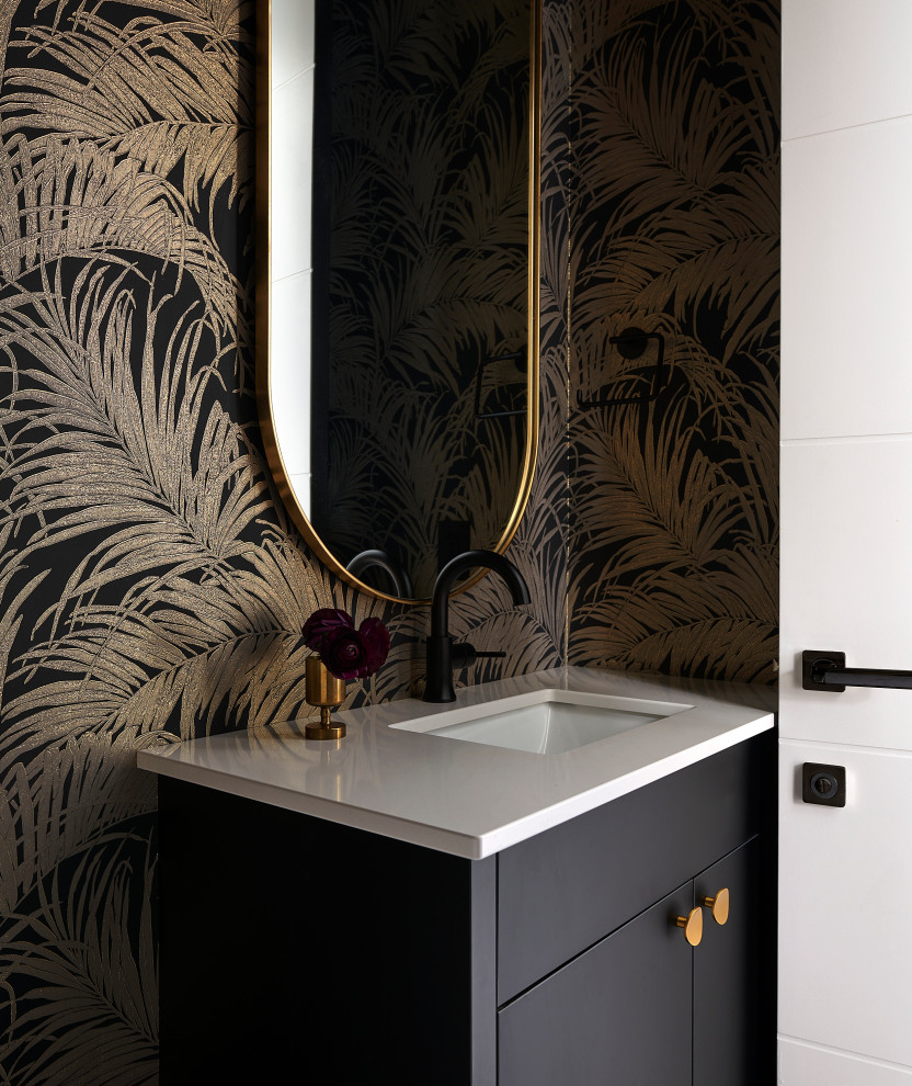 Small contemporary powder room in Toronto with flat-panel cabinets, black cabinets, a one-piece toilet, black walls, porcelain floors, an undermount sink, engineered quartz benchtops, black floor, white benchtops, a freestanding vanity and wallpaper.