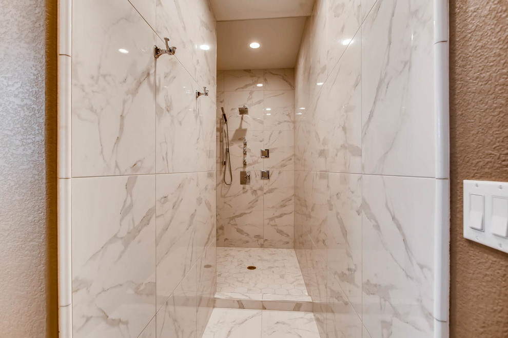 Large traditional bathroom in Denver with shaker cabinets, white cabinets, brown walls, marble floors, an undermount sink, quartzite benchtops, white floor, a freestanding tub, an alcove shower, gray tile, white tile and stone tile.