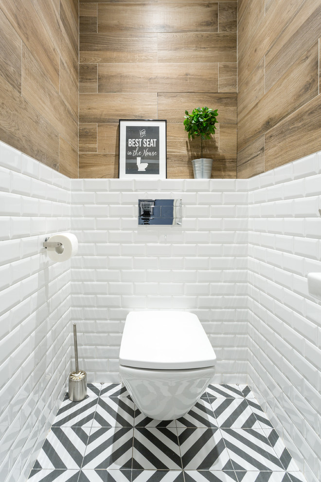 Design ideas for a mid-sized scandinavian powder room in Moscow with flat-panel cabinets, white cabinets, a wall-mount toilet, white tile, ceramic tile, white walls, ceramic floors, a vessel sink, engineered quartz benchtops, black floor and grey benchtops.