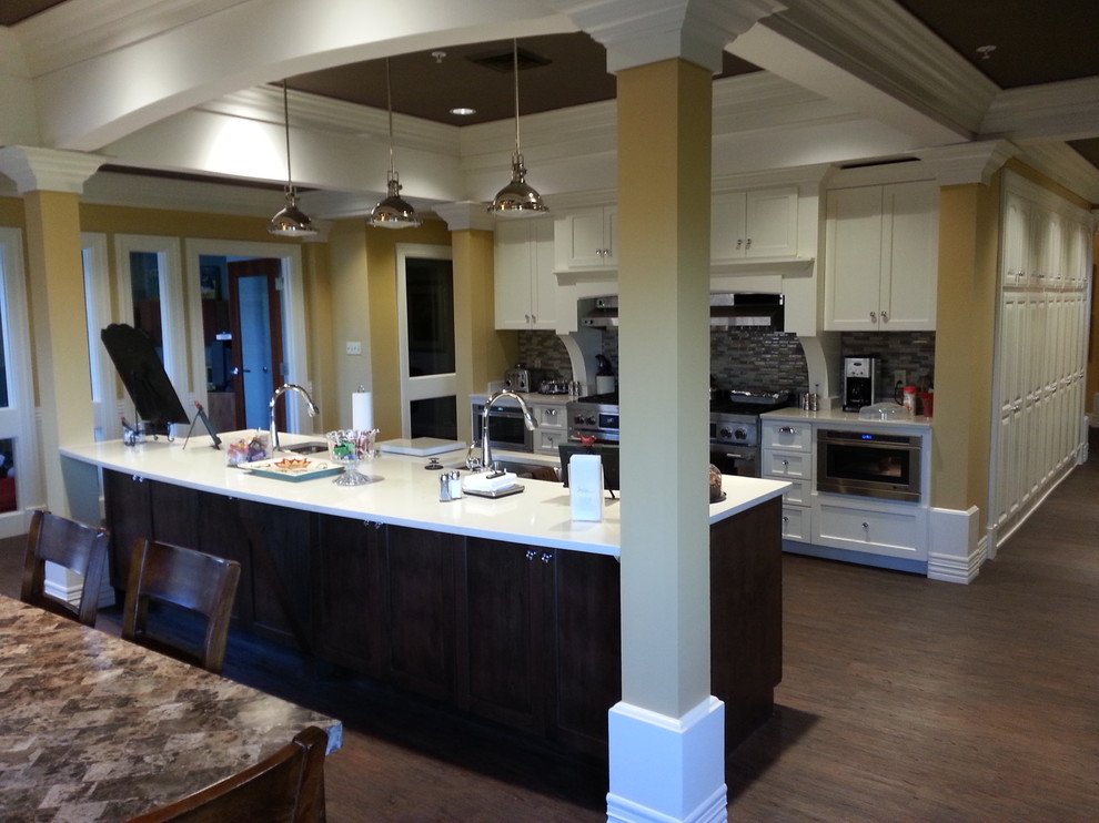 Inspiration for a mid-sized transitional galley dark wood floor and brown floor eat-in kitchen remodel with an undermount sink, shaker cabinets, white cabinets, quartz countertops, gray backsplash, matchstick tile backsplash, stainless steel appliances and an island