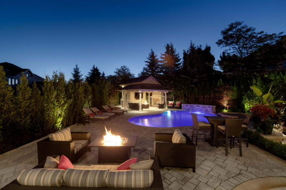 Design ideas for a large transitional backyard full sun garden for summer in Toronto with a fire feature and concrete pavers.