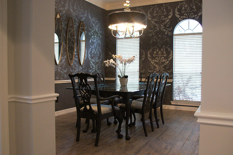 Mid-sized transitional ceramic tile enclosed dining room photo in Houston with black walls