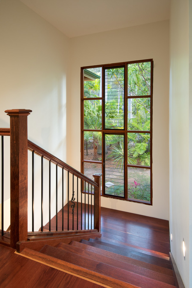 Inspiration for a large tropical wood u-shaped staircase in Brisbane with wood risers and wood railing.