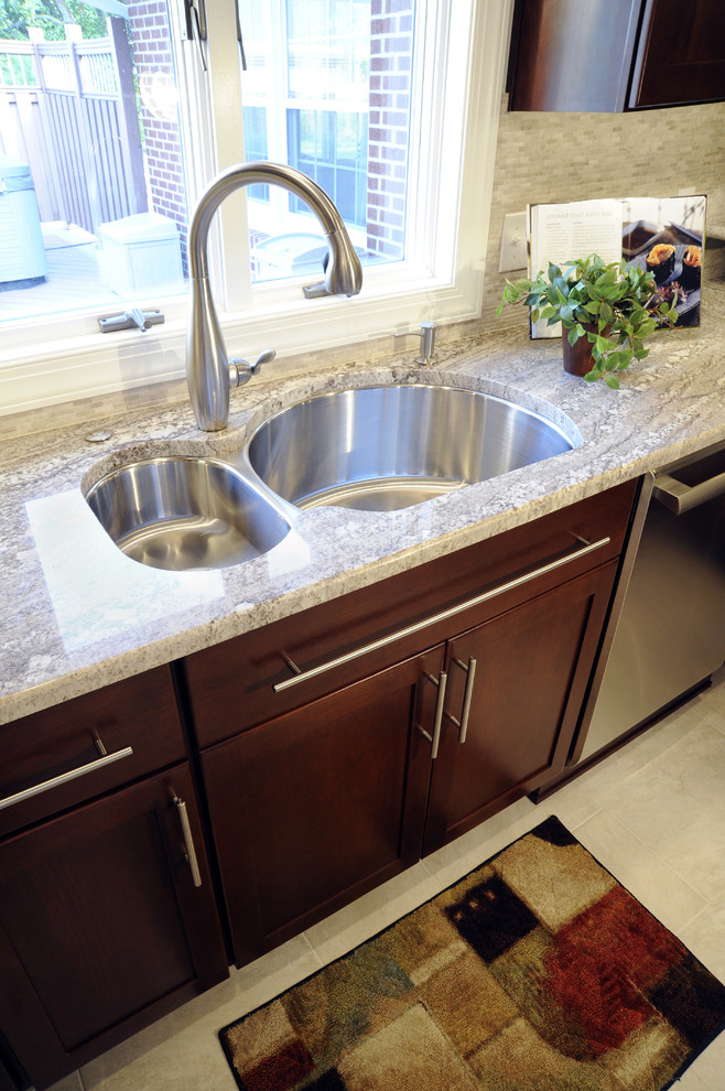 Eat-in kitchen - large transitional u-shaped ceramic tile and beige floor eat-in kitchen idea with a double-bowl sink, shaker cabinets, dark wood cabinets, granite countertops, beige backsplash, mosaic tile backsplash, stainless steel appliances and a peninsula