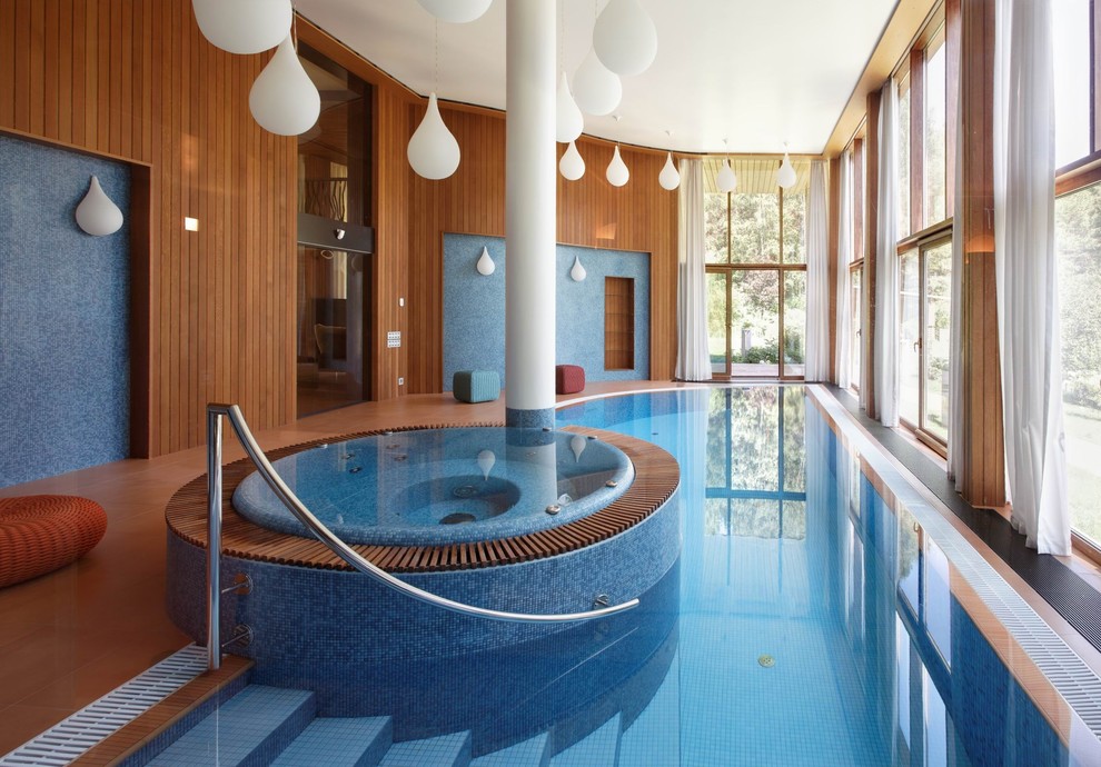 Photo of a contemporary indoor pool in Moscow with a hot tub.