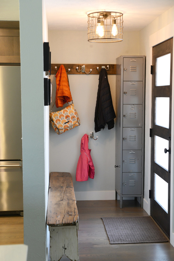 Mudroom - small transitional dark wood floor and brown floor mudroom idea in Denver with white walls and a glass front door